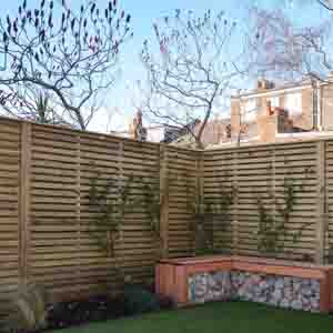 Horizontal slatted screen used as a decorative backdrop to raised planters.