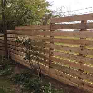 Timber slatted fence with staggered boards adding texture and interest.