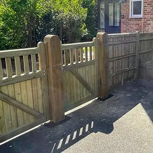 Timber pedestrian gate with slatted top rail and heavy timber posts at residential entrance, installed by Green Leaves Fencing & Gates in East Grinstead