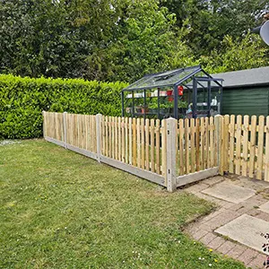 Timber picket fencing along a landscaped garden path, installed by Green Leaves Fencing & Gates in East Grinstead.