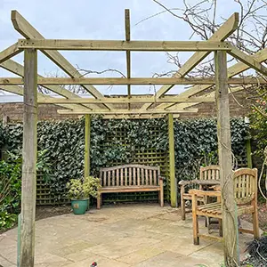 Bespoke timber pergola garden structure with climbing plants, designed and installed by Green Leaves Fencing & Gates in East Grinstead.