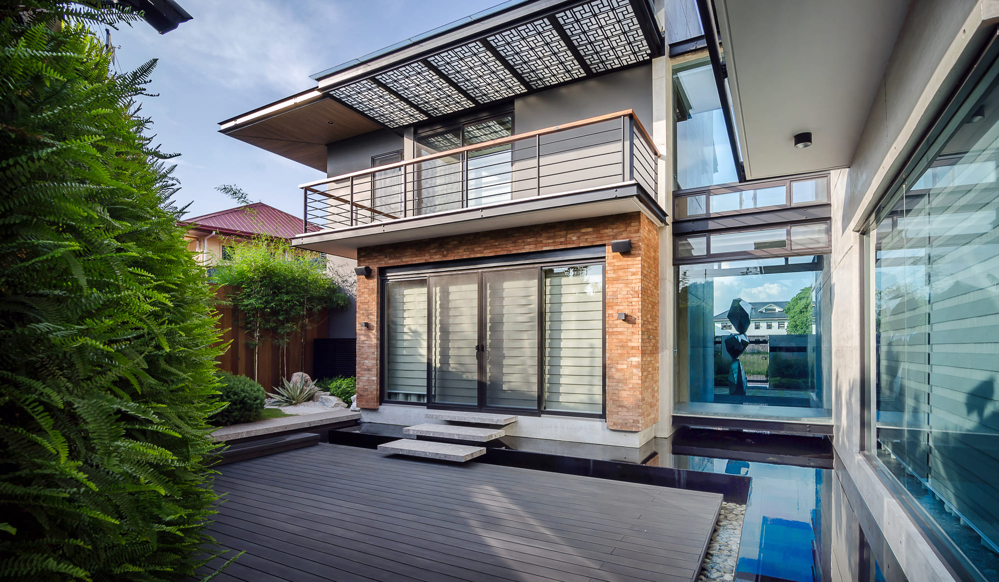 Walls of Green — The interiror rooms of this modern home have large glass windows that reflect the landscaping from outside, essentially bringing the outdoors to the comforts of the inside.