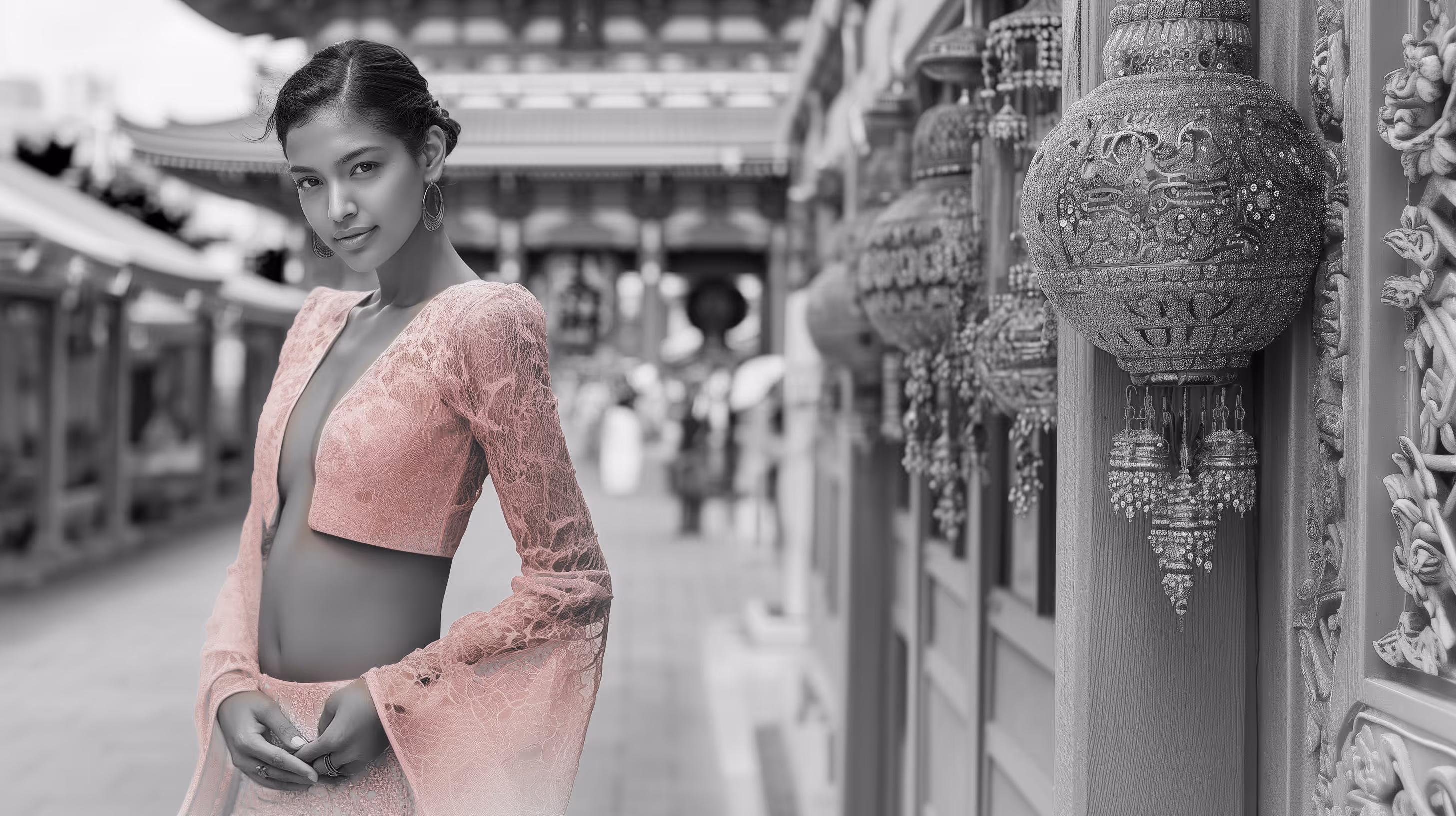 Woman in pink lace outfit posing on a street with traditional Asian lanterns and architecture in the background.