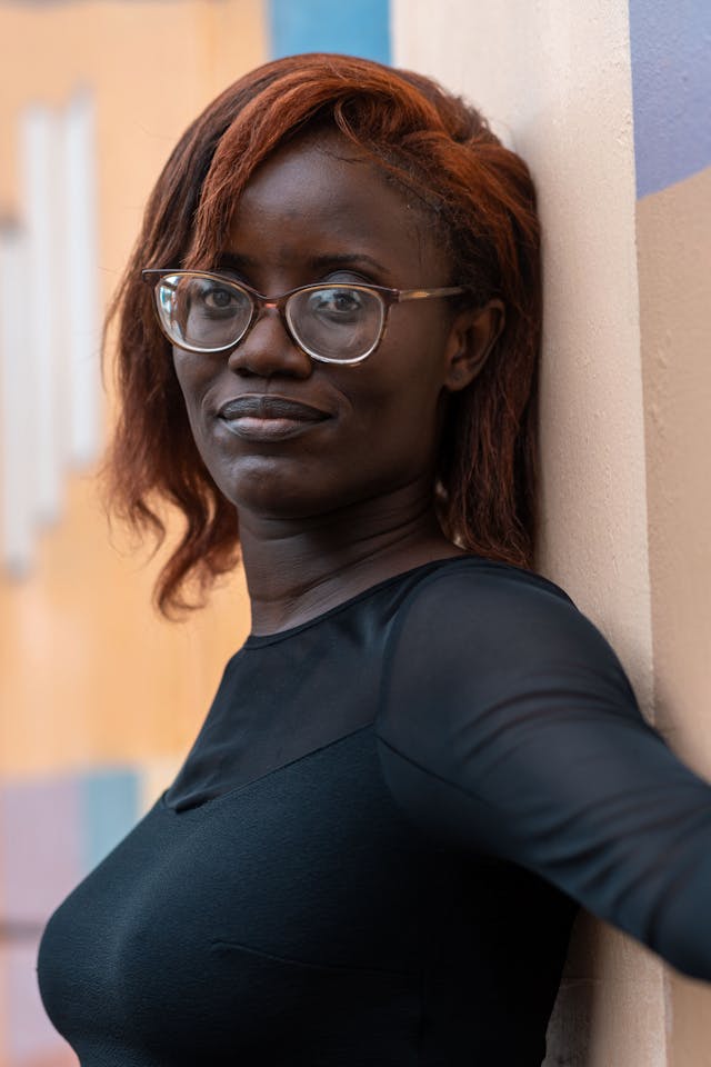 Image of a woman with red hair and glasses.