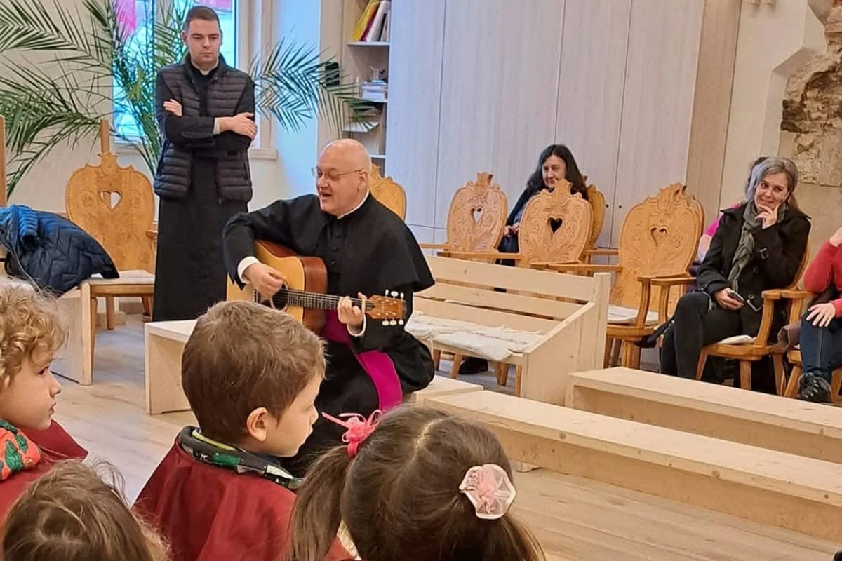 Kántálás a kolozsvári Szent Mihály Római Katolikus plébánián, ahol László Attila főesperes gitárral kíséri a közös éneklést