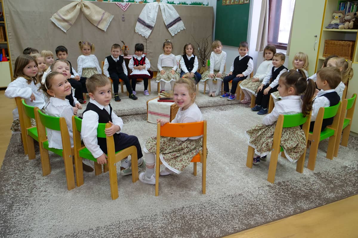 Copii de grădiniță, îmbrăcați în haine de sărbătoare, stau în cerc de ziua culturii maghiare.