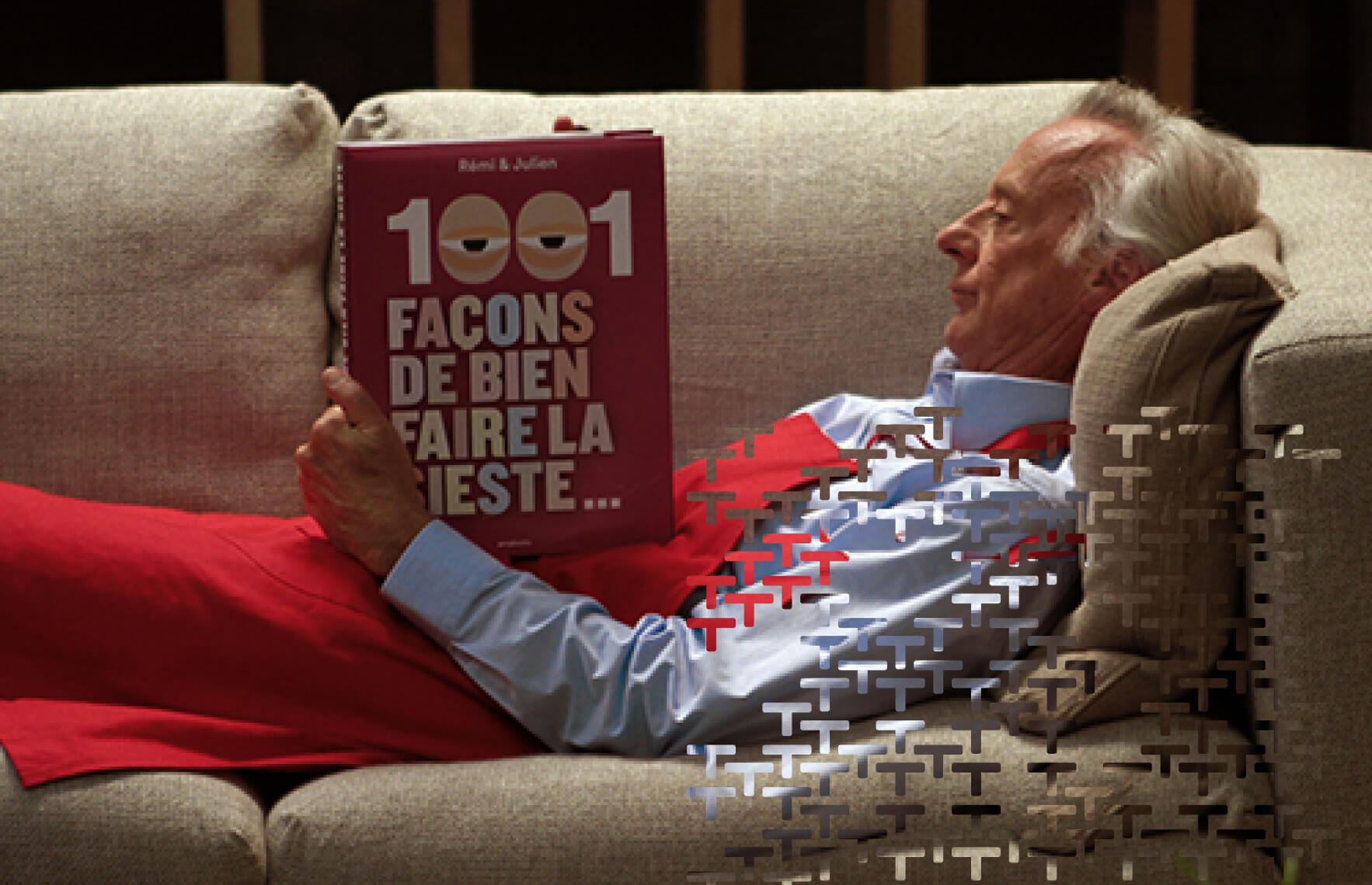 Person laying on a couch, reading a book