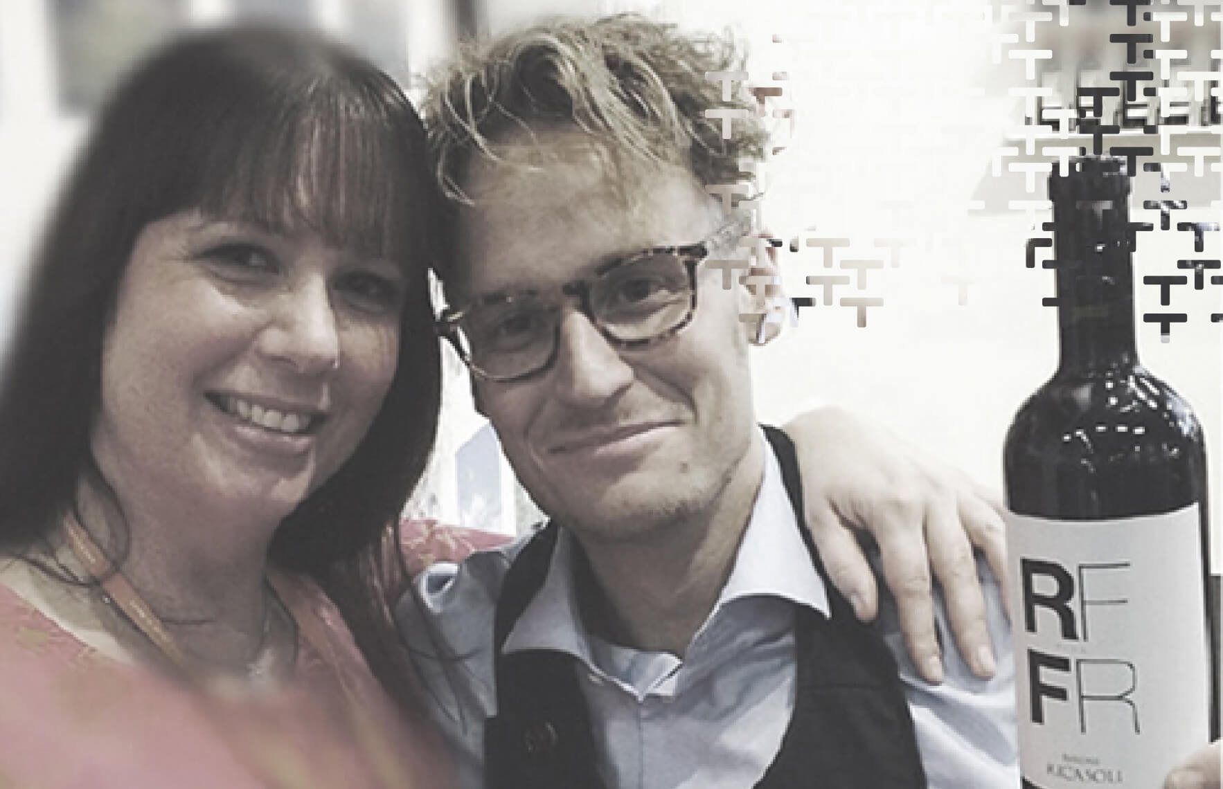 People smiling with a glass of wine