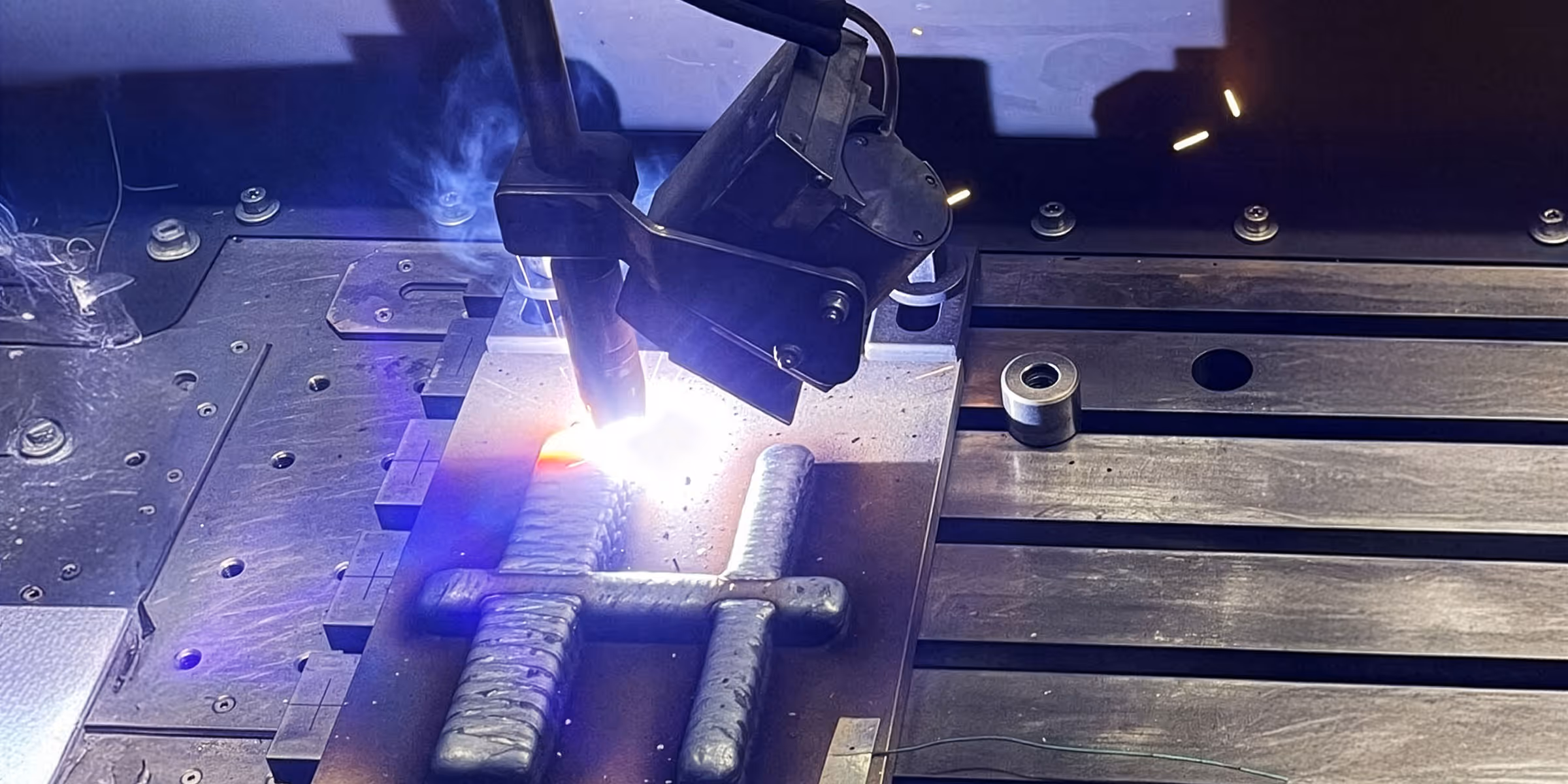 Glowing metal component during hot forming at Heggemann, showcasing advanced solutions for aerospace-grade alloys and complex geometries