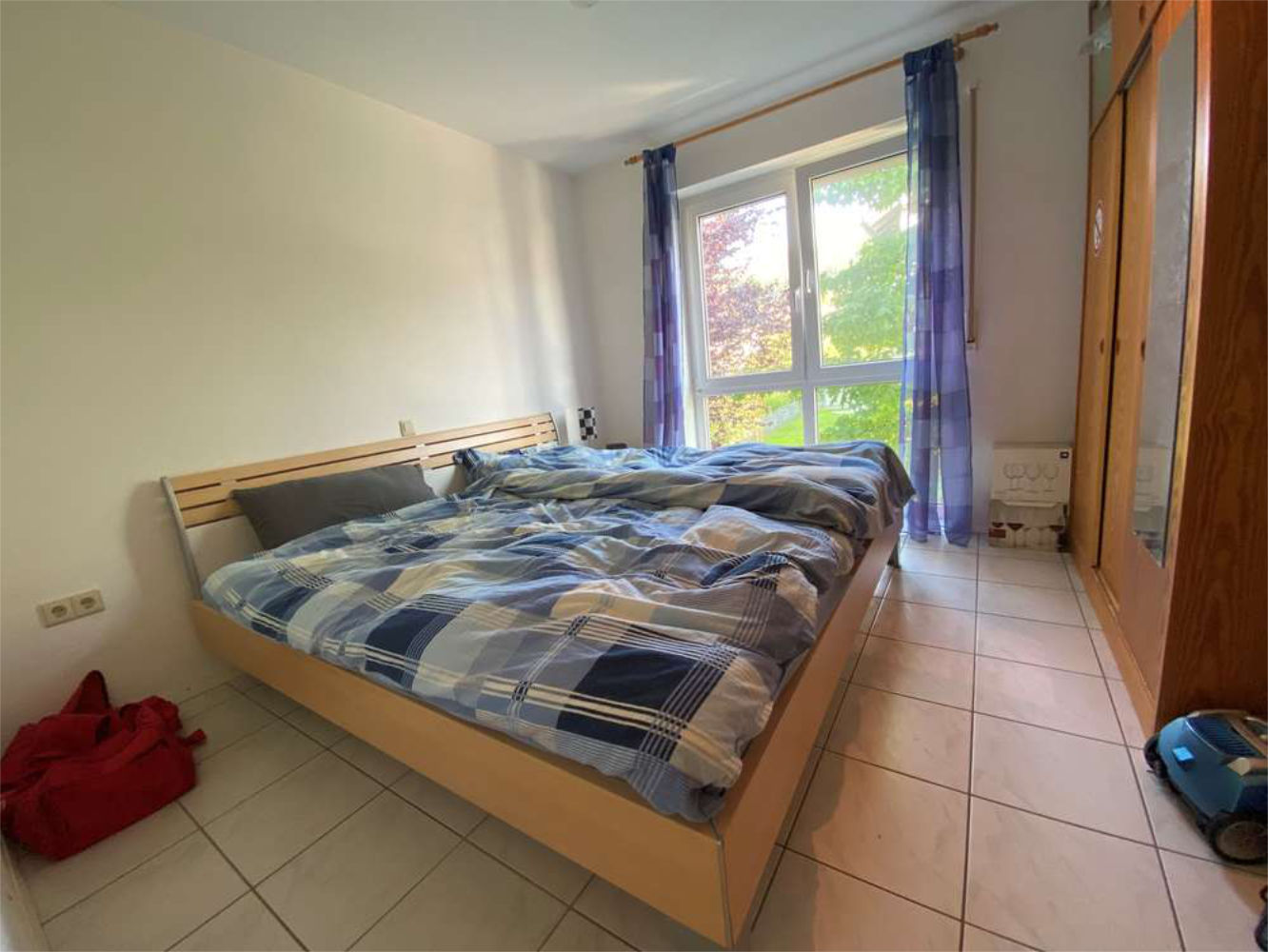 Schlafzimmer mit großem Fenster und Gartenblick, Immobilie von Zeltsperger.