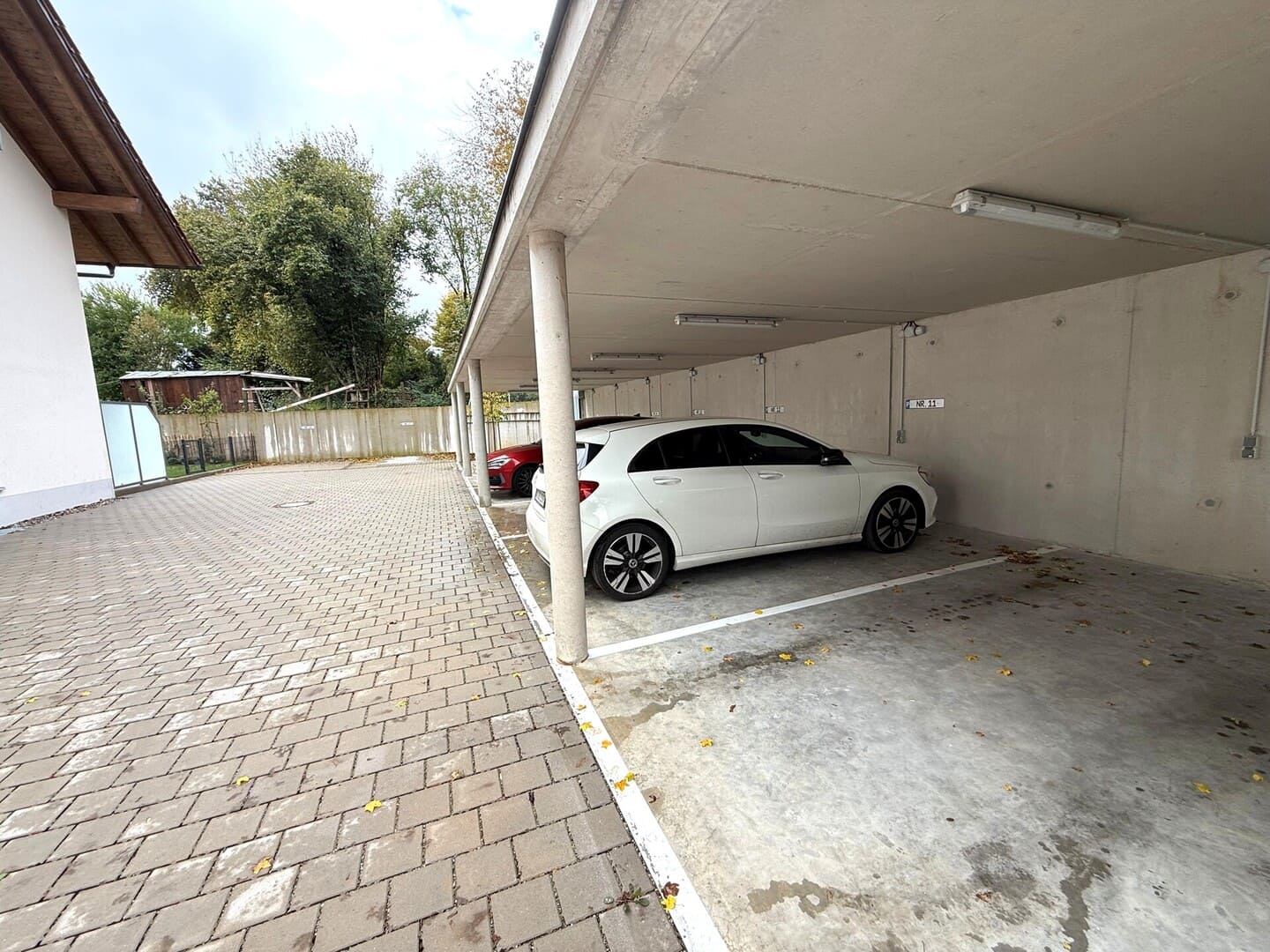 Carport und Stellplatz mit gepflasterter Zufahrt – komfortable Parkmöglichkeit an der Wohnung in Obing