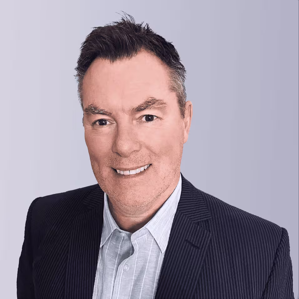 Two professionals shaking hands outdoors, symbolizing partnership and collaboration.