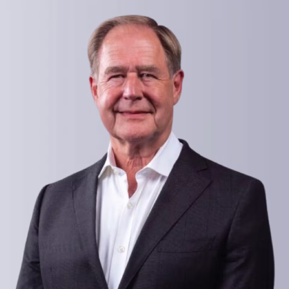 Two professionals shaking hands outdoors, symbolizing partnership and collaboration.