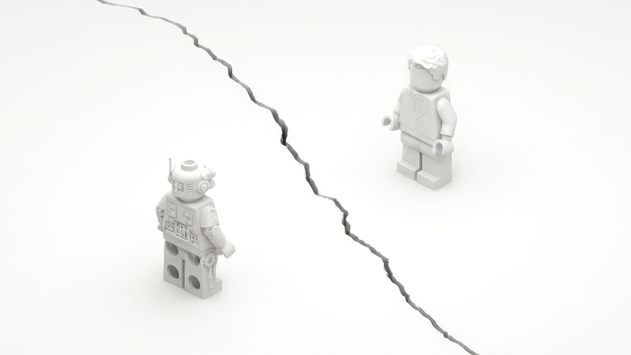 Two white LEGO figures, a robot and a man in a suit, standing on opposite sides of a jagged crack in a white surface.