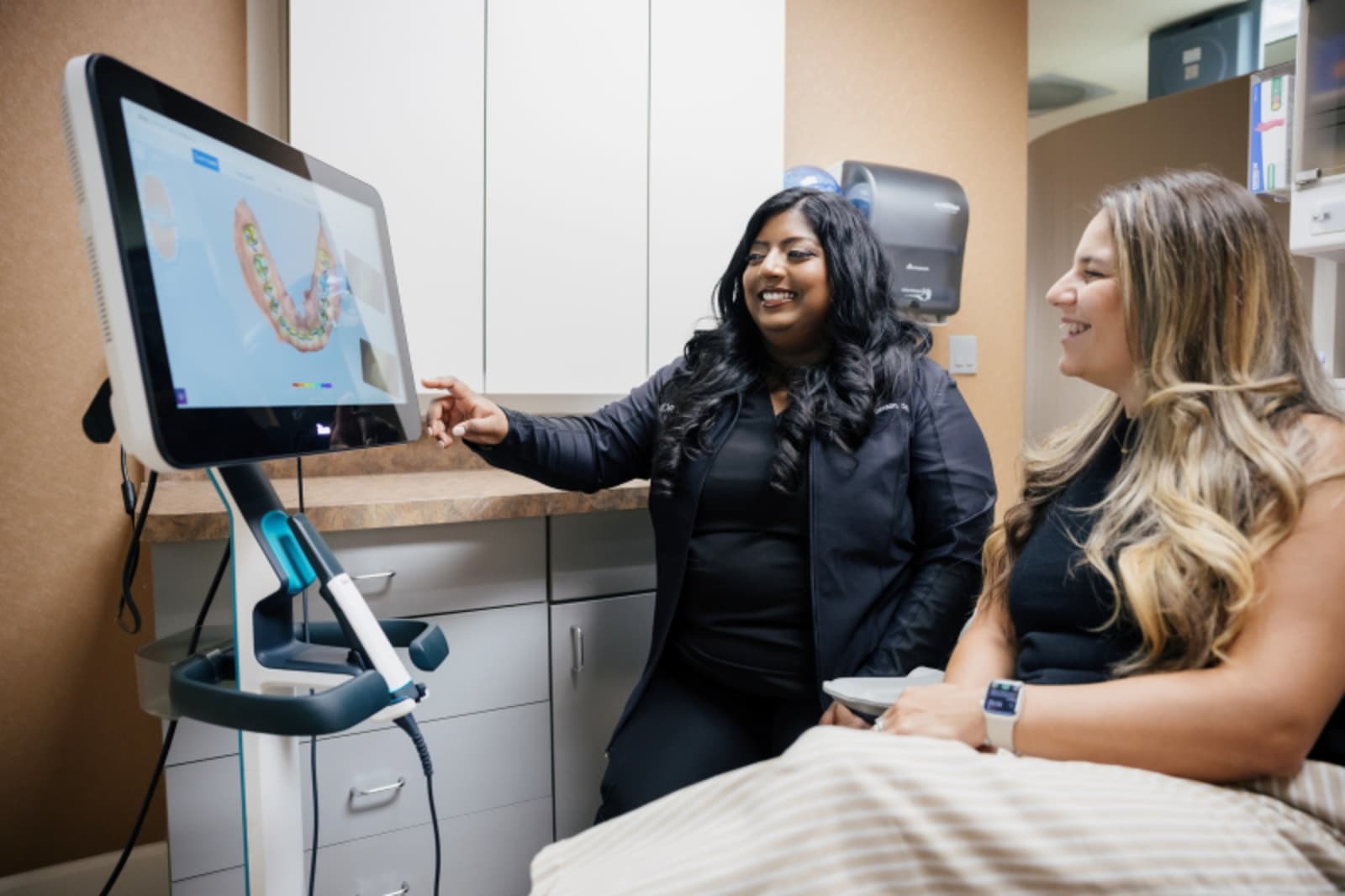 Dentist showing digital scan results to a patient on a computer monitor