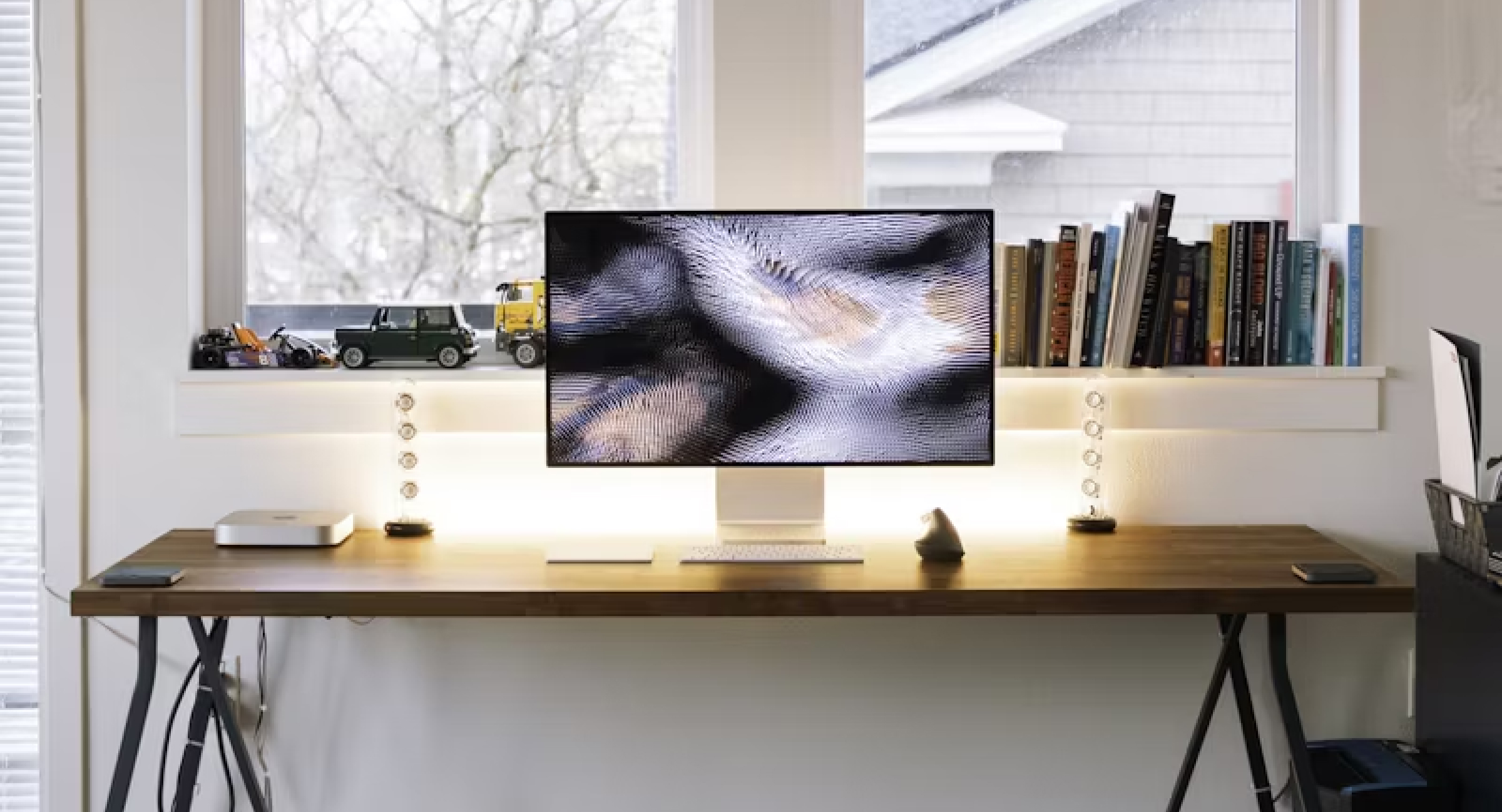 A computer monitor sitting on top of a wooden desk.