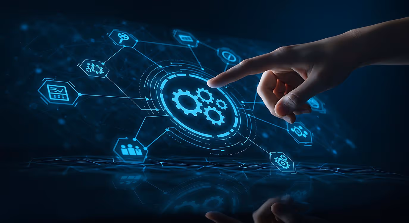 Hand pointing to holographic digital interface with interconnected gear icons representing technology and automation.