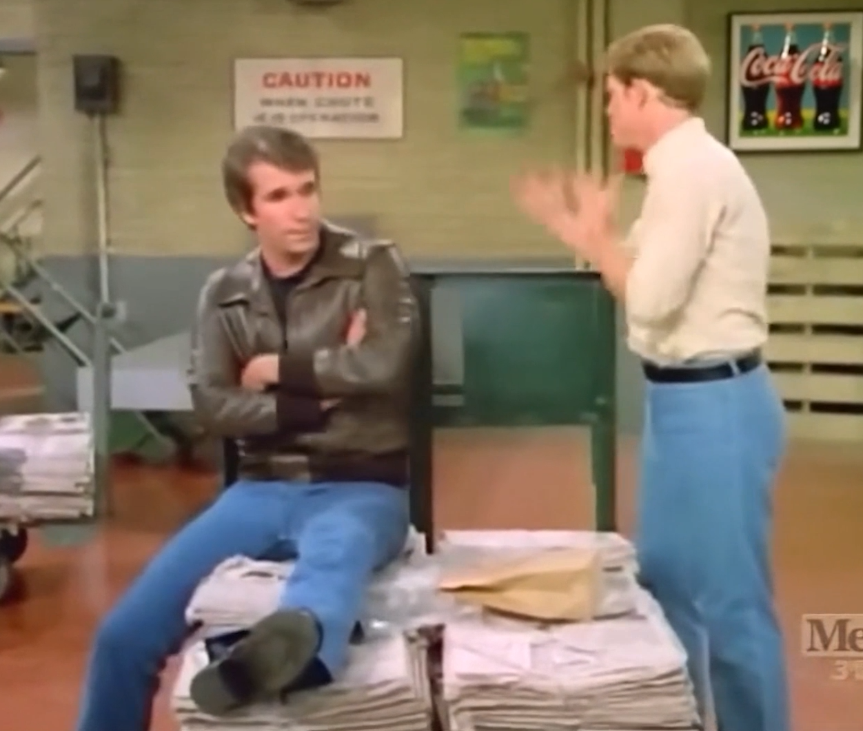 an image of two men in a warehouse talking to one another