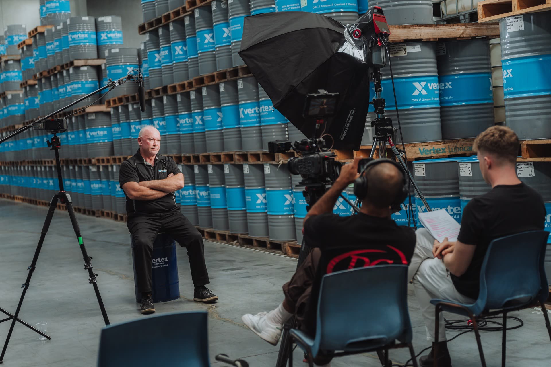 Refined crew filming an interview in a warehouse
