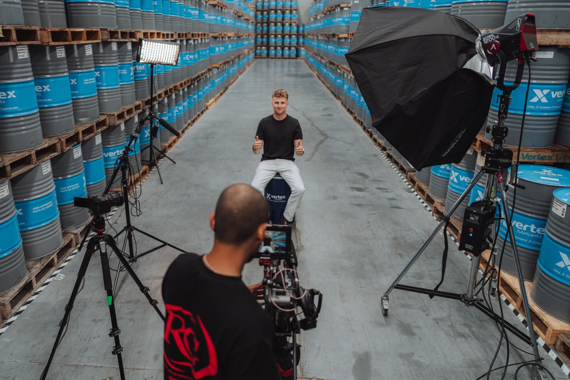 Refined crew filming in a warehouse