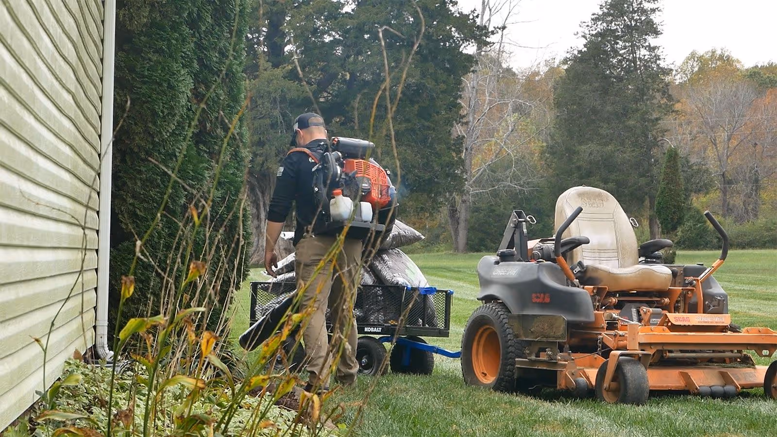 Lawn maintenance workers using commercial mowers and blowers