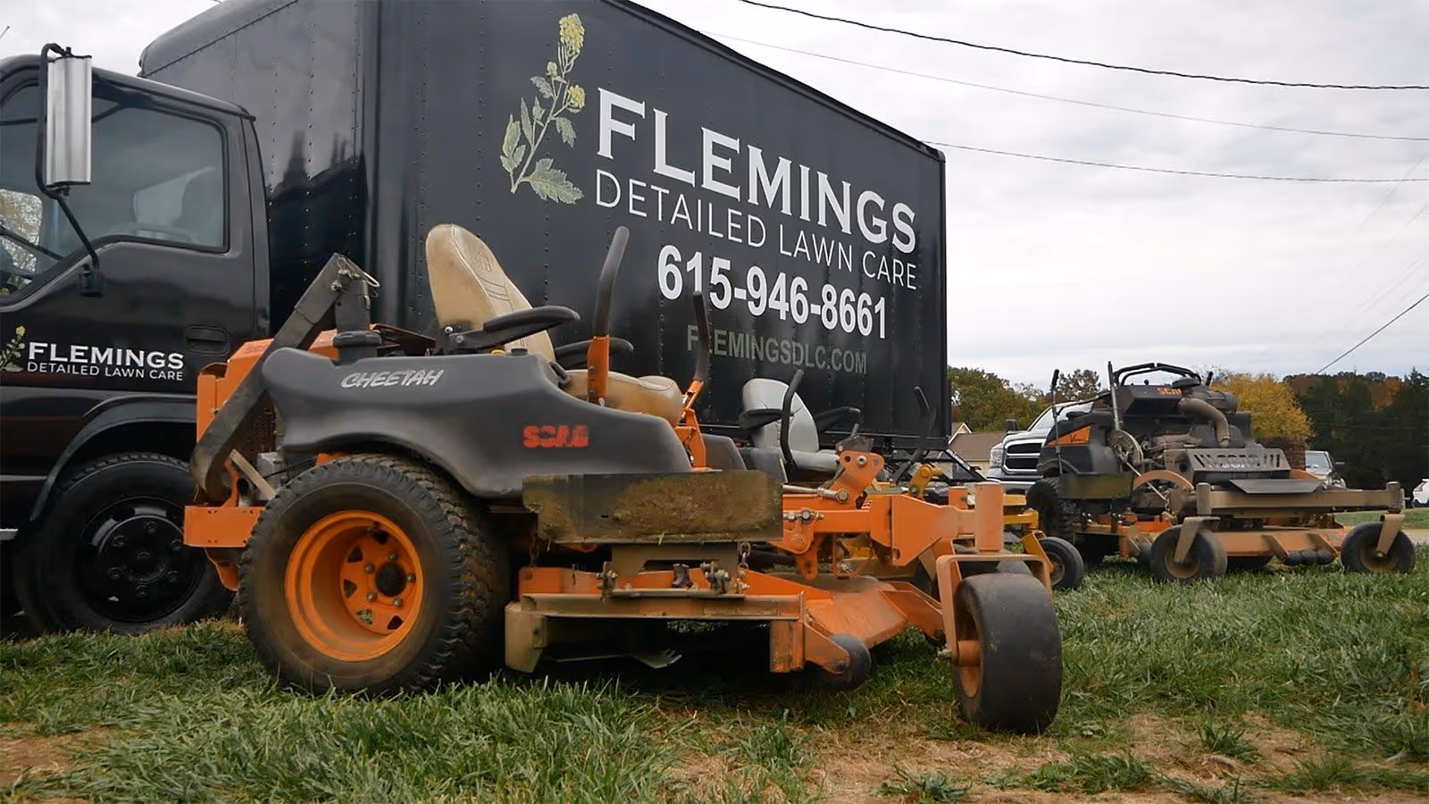 Lawn care crew mowing residential property in Dickson County TN