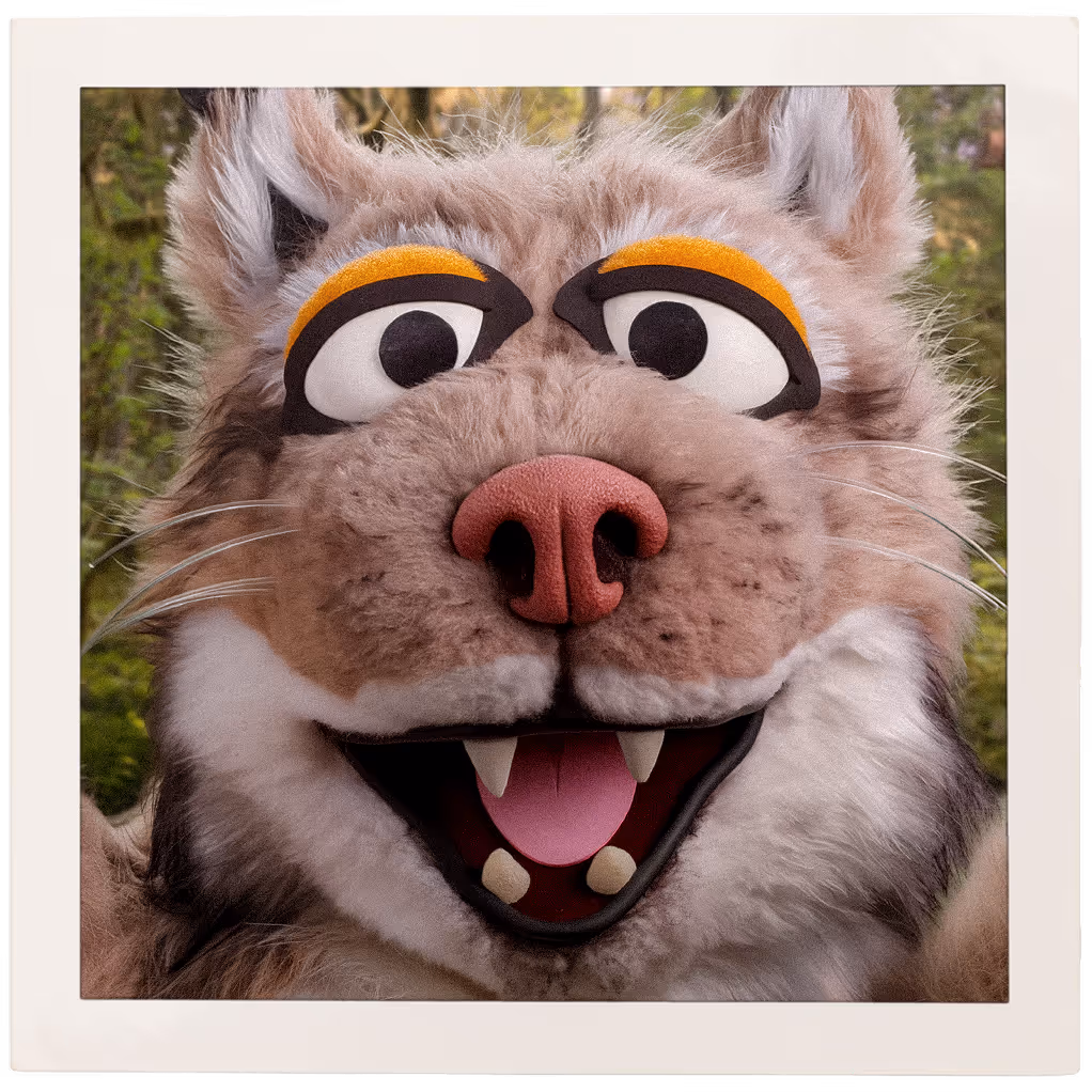 A polaroid of Bruce the lynx smiling for the camera