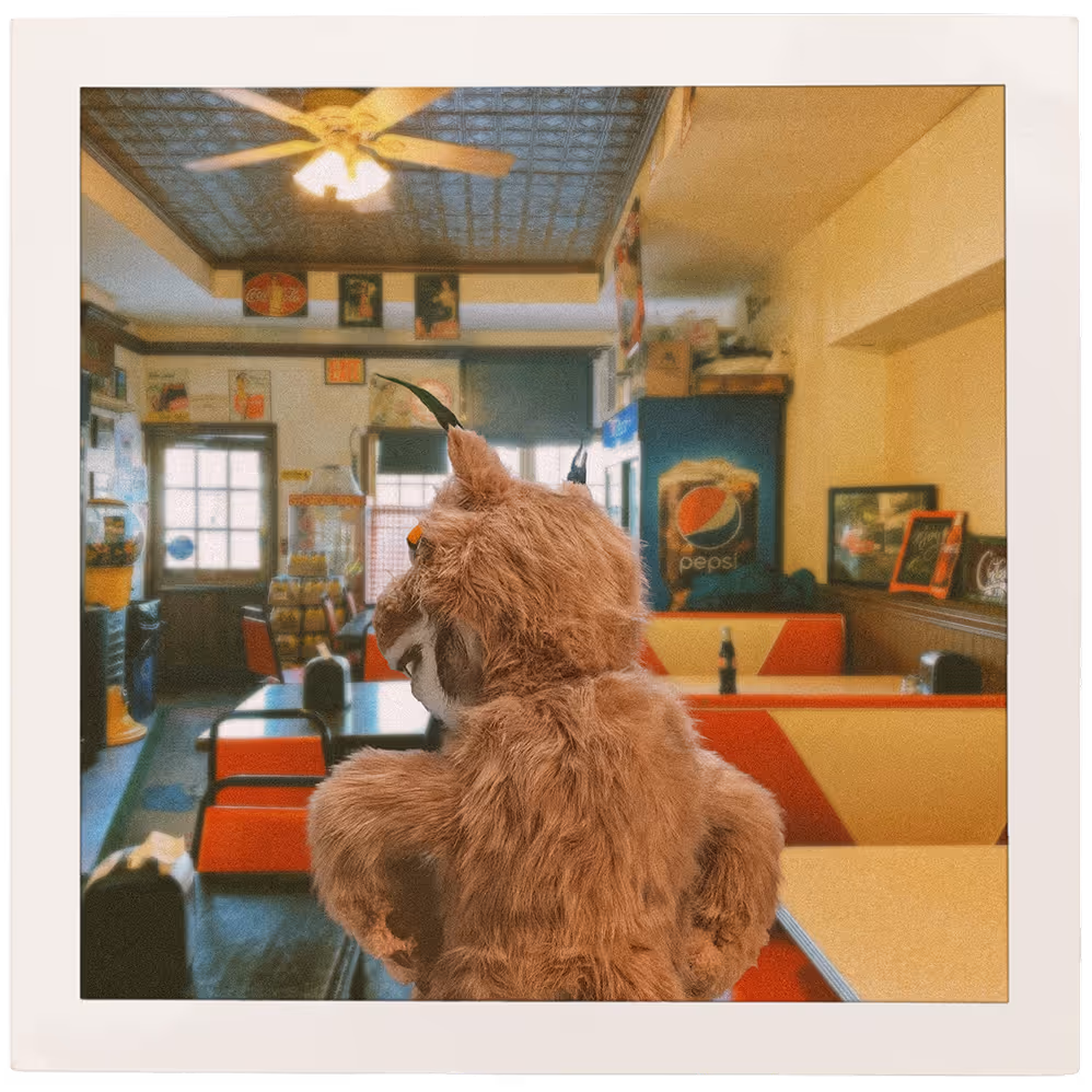 A polaroid of Bruce the lynx eating at a diner