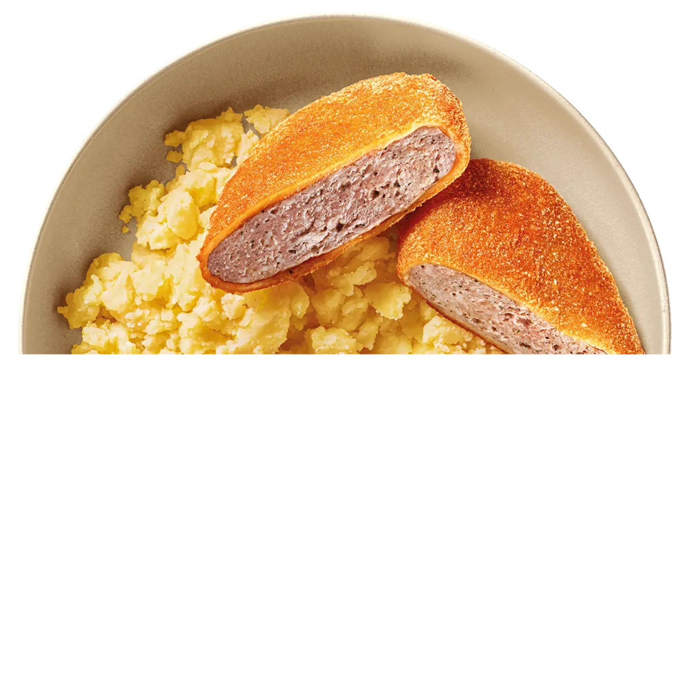 Talíř s bramborovou kaší a dvěma půlkami smaženého holandského řízku.