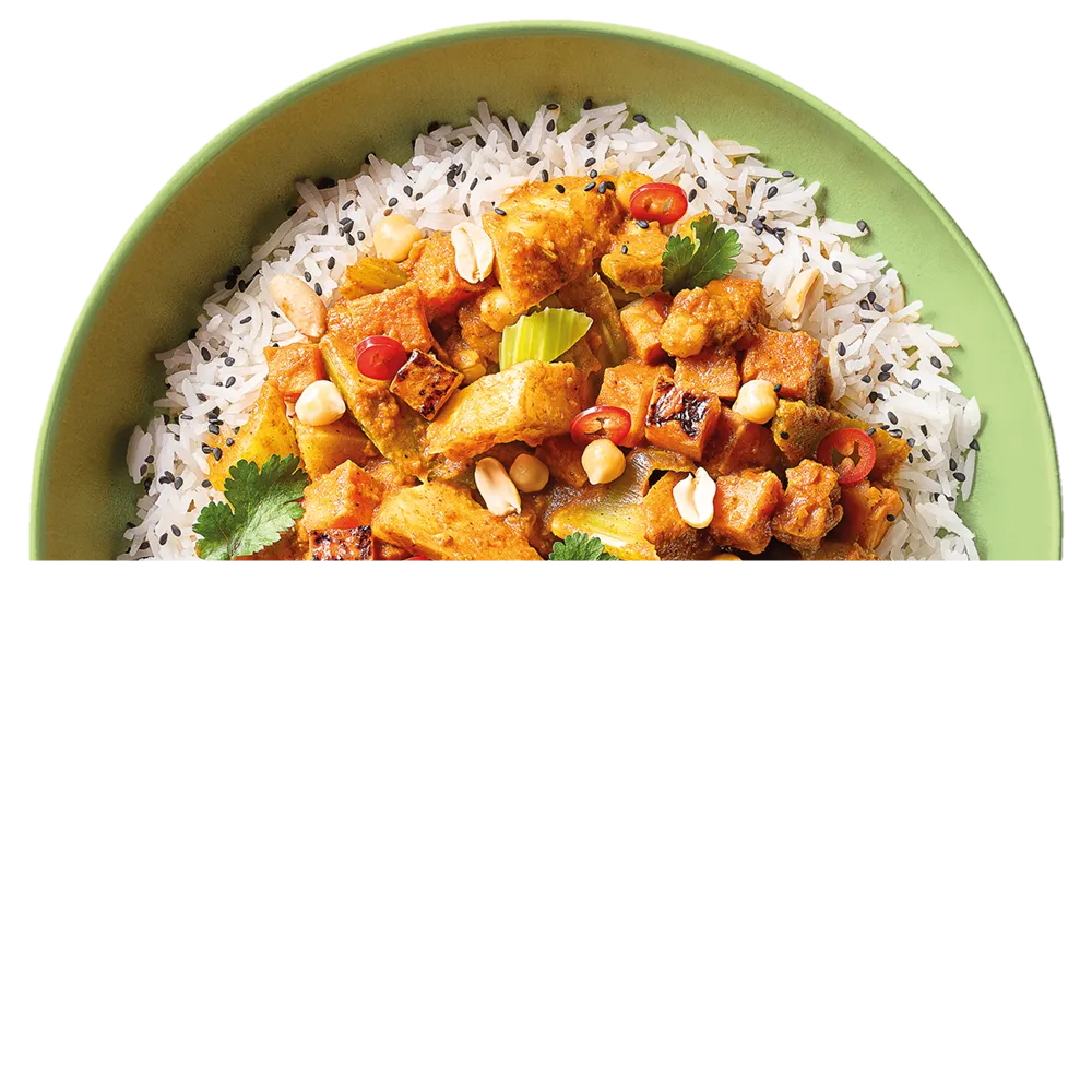 Miska s indickým tikka masala s rýží, cizrnou, arašídy, koriandrem, červenou chilli papričkou a černým sezamem.