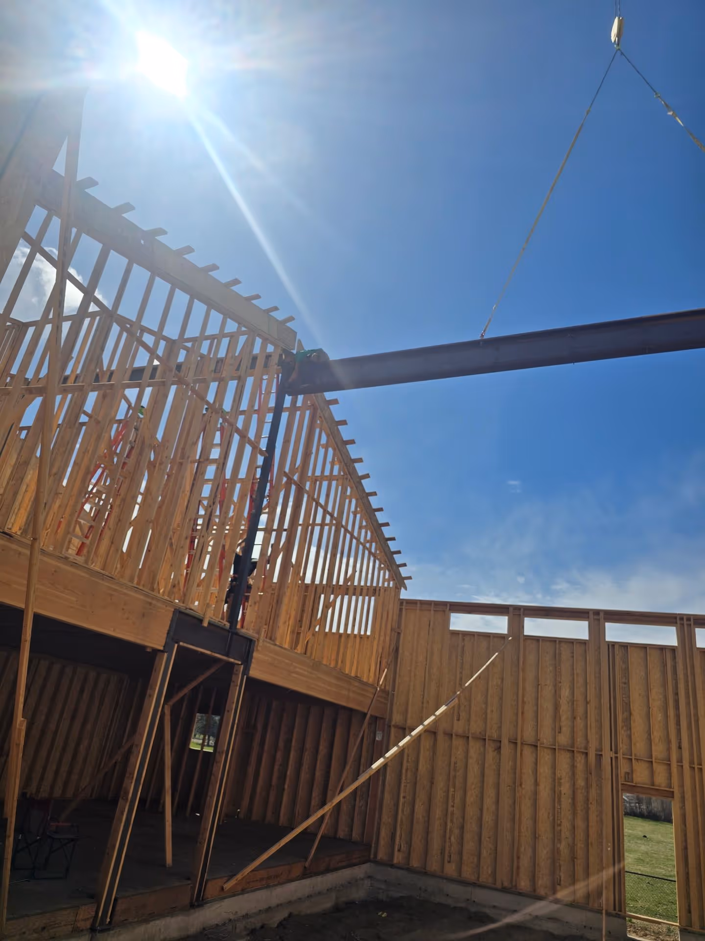 A house under construction under a blue sky.