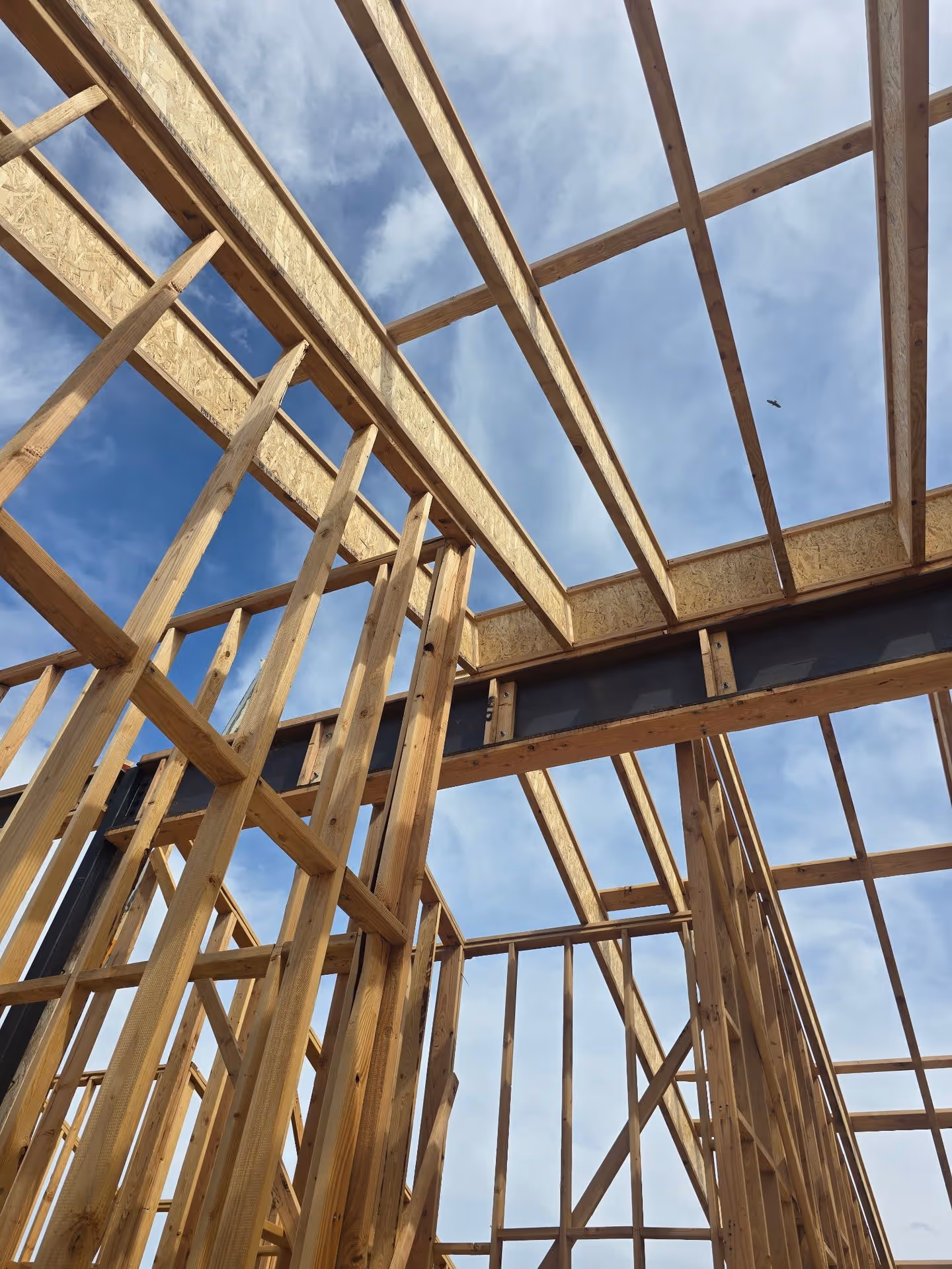 A wooden frame of a house under construction.