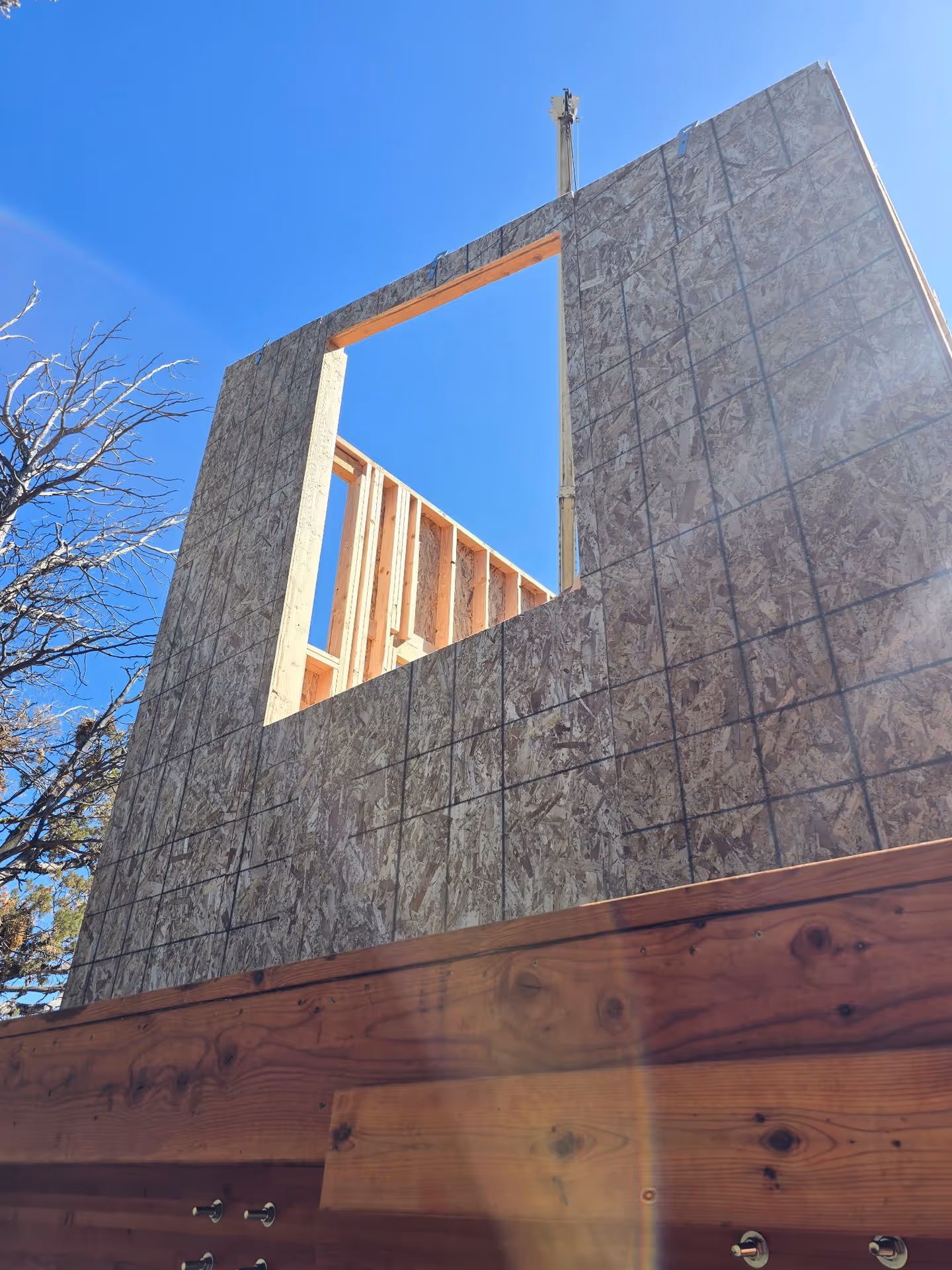 A house under construction with a cross on top of it.