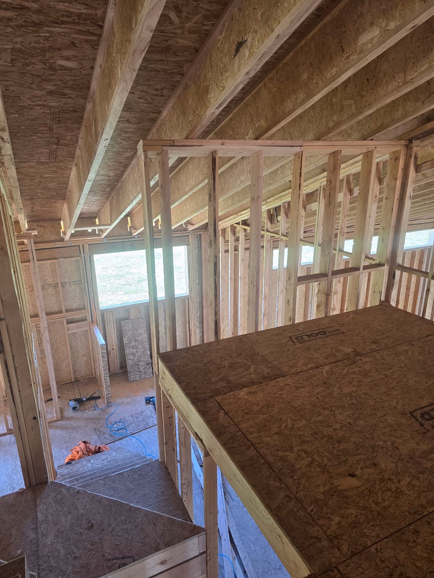 A room that is under construction with a lot of wood.