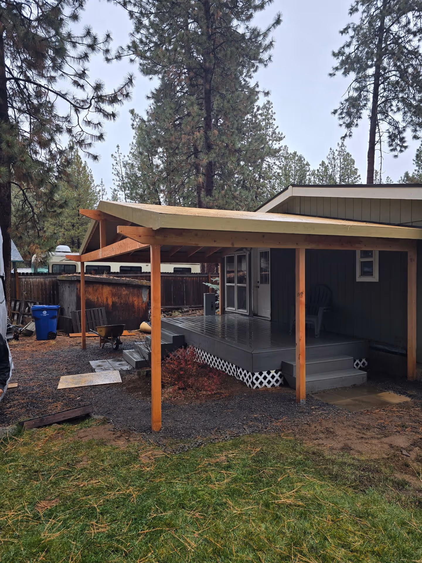 A house with a covered porch and a car parked in front of it.