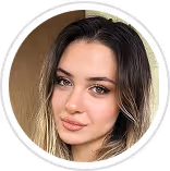 Close-up portrait of a woman with light brown eyes and wavy dark blonde hair inside a circular frame.