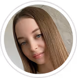 Close-up portrait of a woman with long straight brown hair and blue eyes smiling softly.