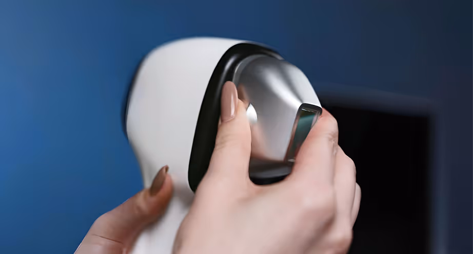 Hands adjusting the metallic lens section of a white VR headset against a dark blue background.