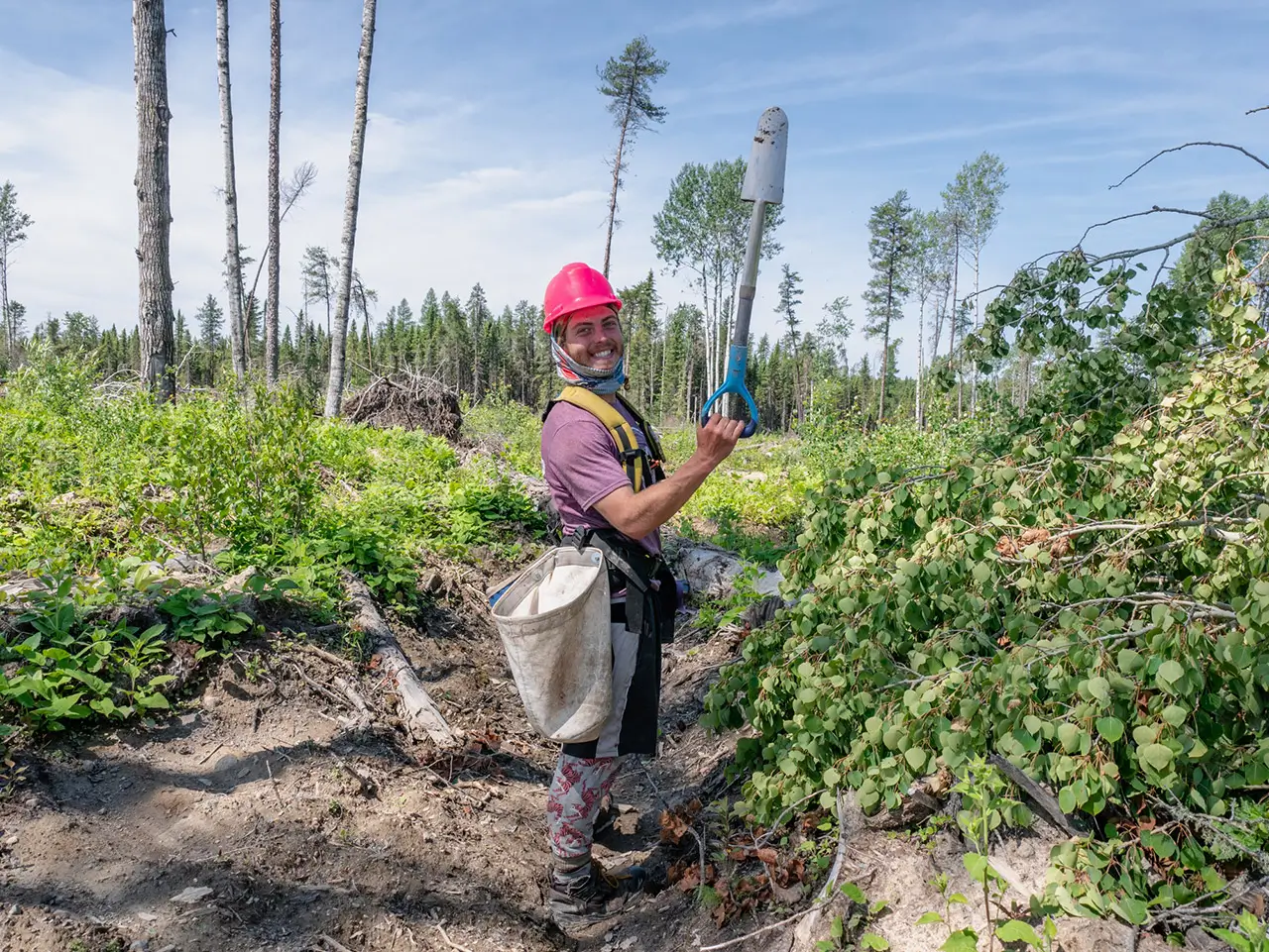 Members of tree planting team unloading from helicopter