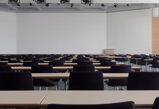 San Jose, CA classroom with chairs and screen, focusing on mental health, academic stress, and development issues.