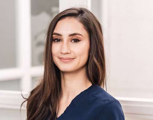 Headshot of Dr. Courtney Maloney in a blue scrub top smiling at the camera.