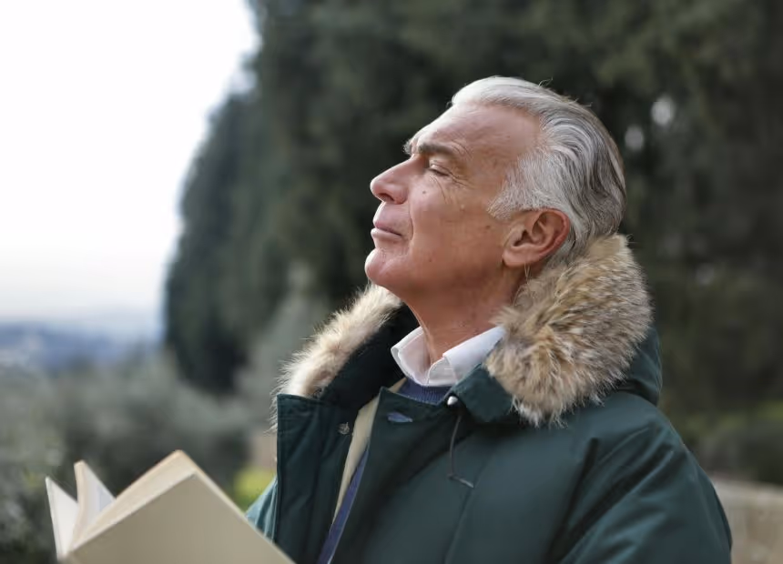 Man in parka reading about Dialectical Behavior Therapy's effectiveness for mood disorders, San Jose, CA, stress tolerance.