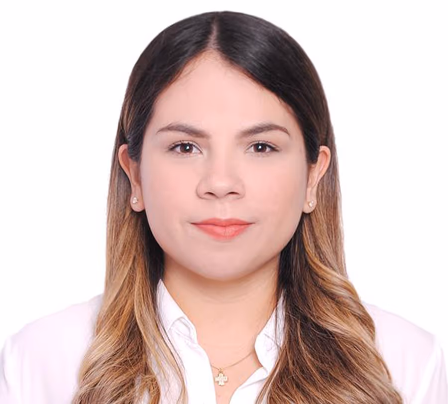Portrait of practice assistant Marisol Leal with long, wavy brown hair wearing a white shirt, looking straight at the camera.