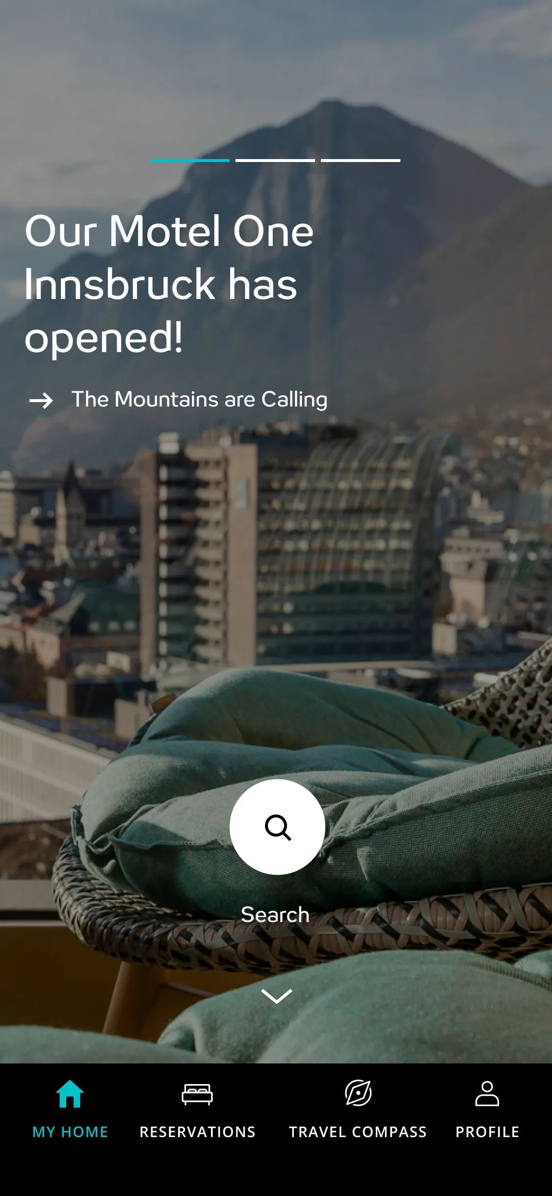 Homescreen of the motel one app, teaser with view of a city with a mountain background taken from a balcony with green cushioned wicker chairs, showing text about Motel One Innsbruck opening.