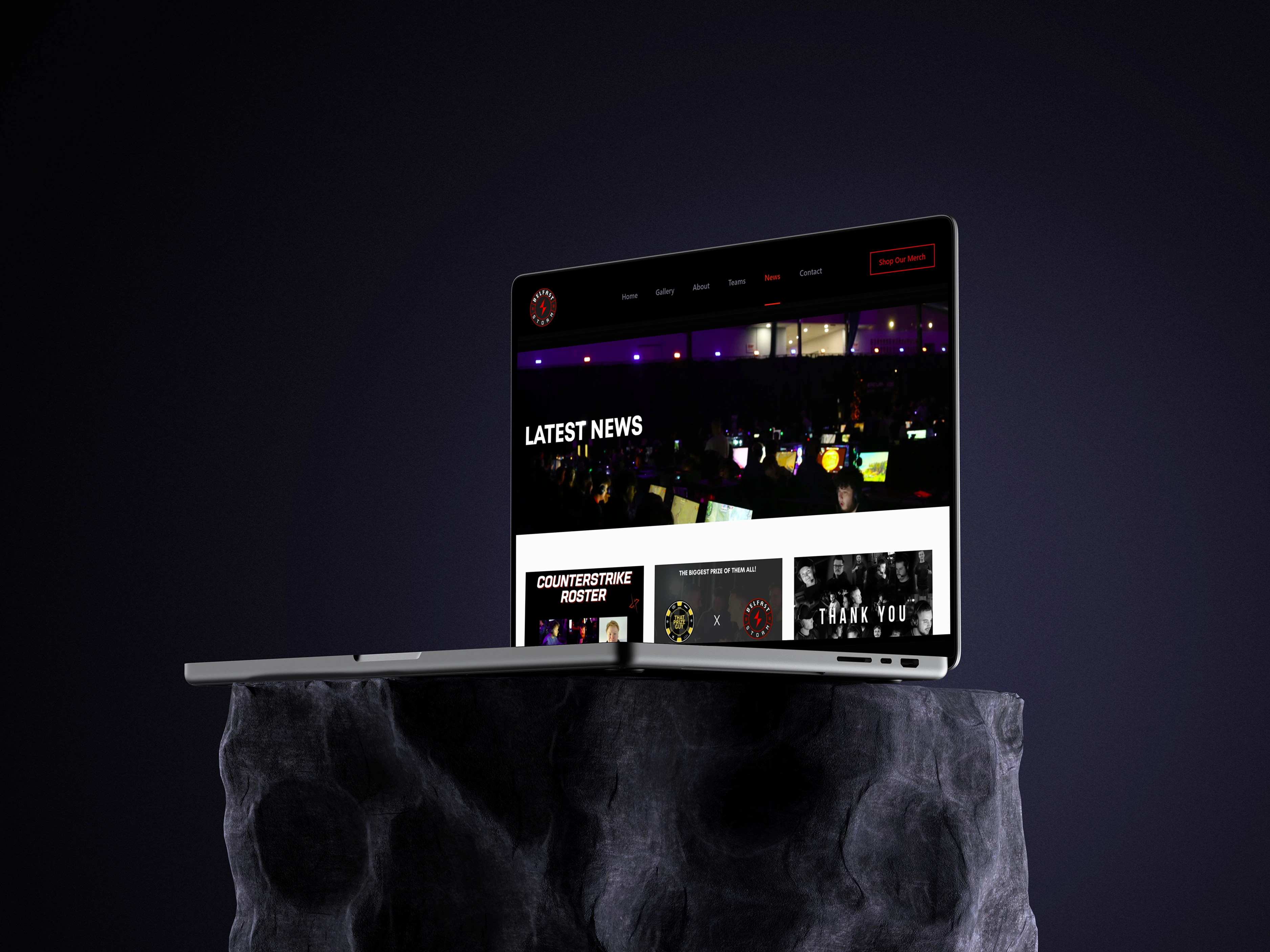 Laptop sitting on a rock showing client website