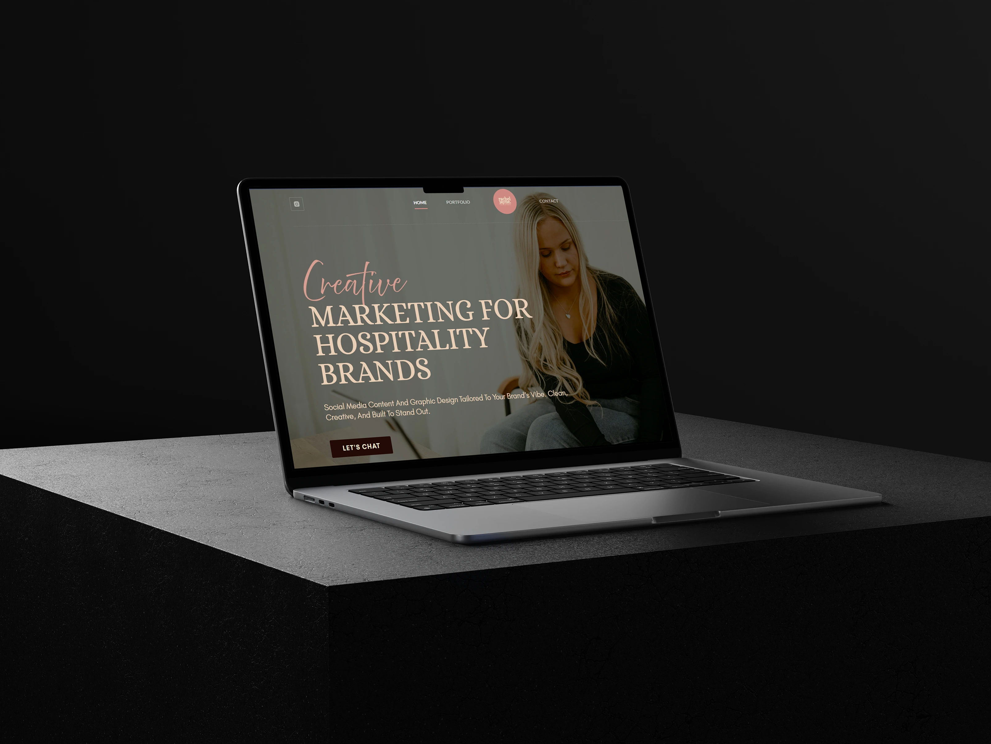 Laptop sitting on a rock showing client website