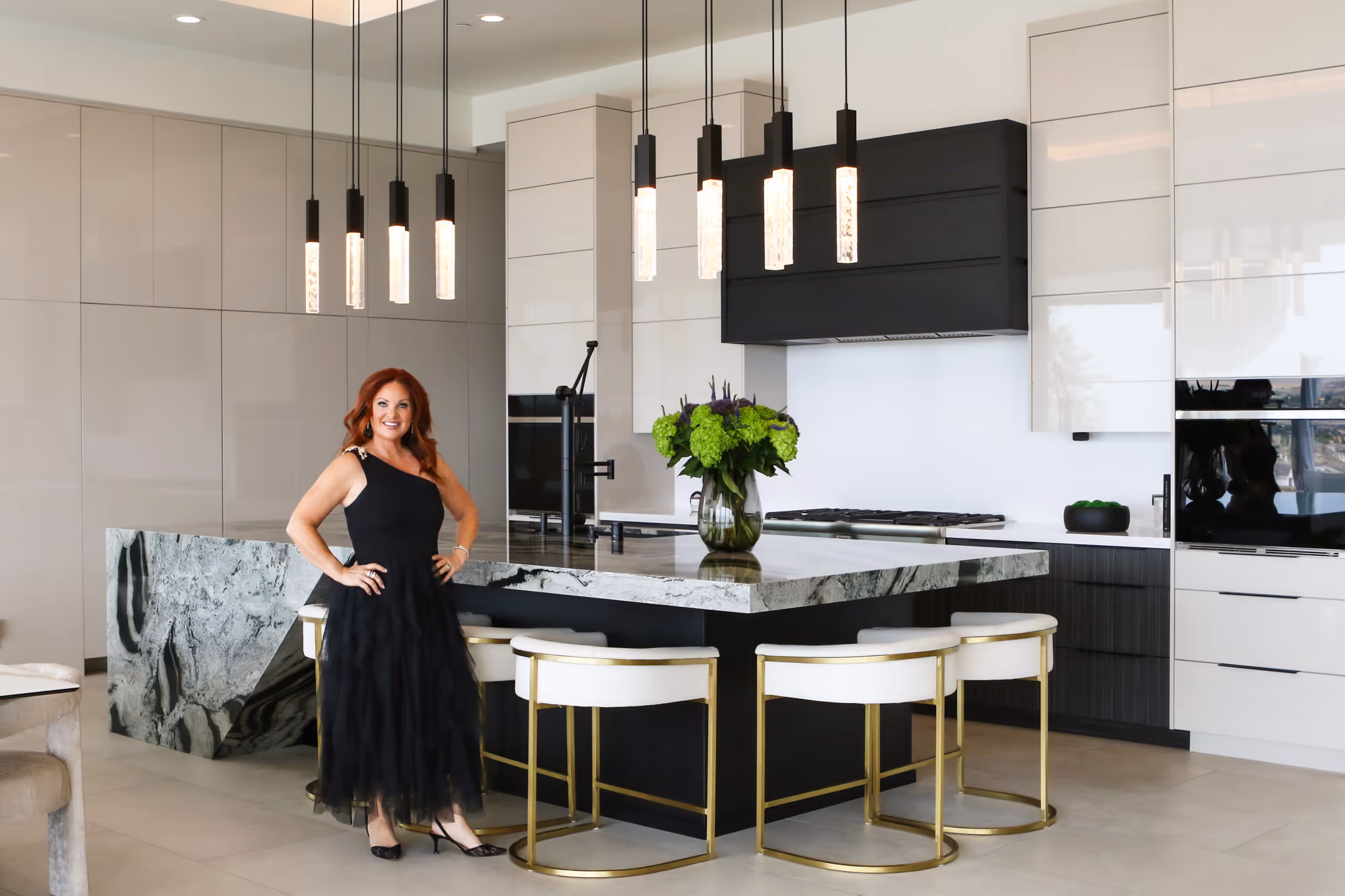 tami teel designs owner interior designer standing kitchen