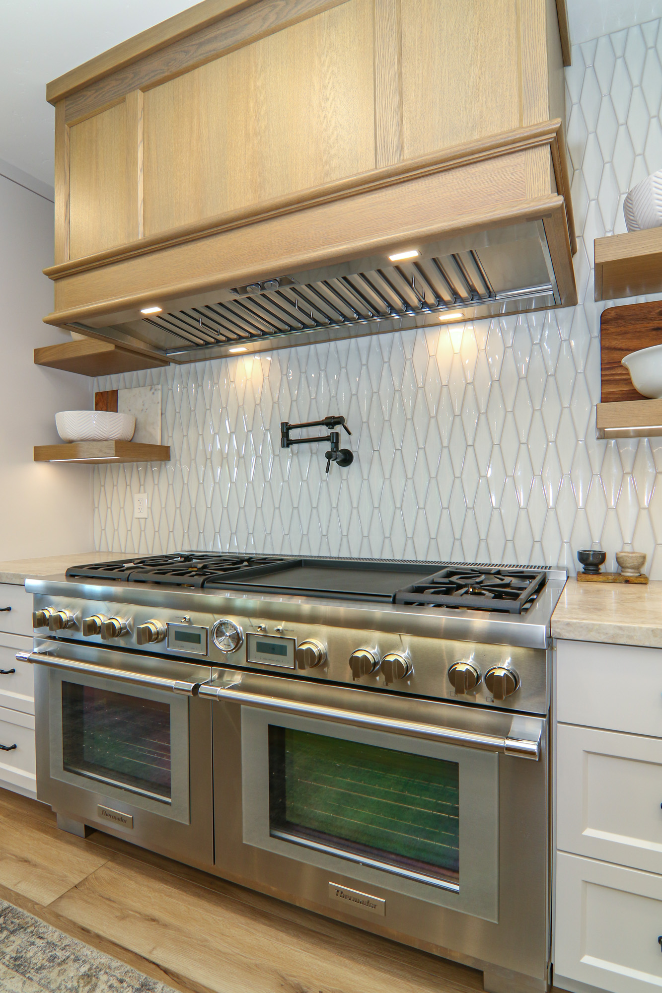 Luxury kitchen in Penryn, CA featuring modern double oven with stainless steel finish and hexagonal tile backsplash