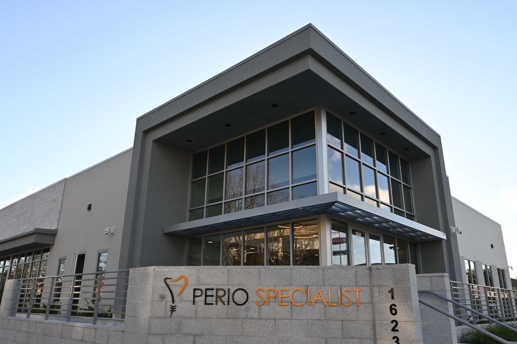Modern exterior of Perio Specialist office in Roseville, CA featuring large windows and a contemporary design.