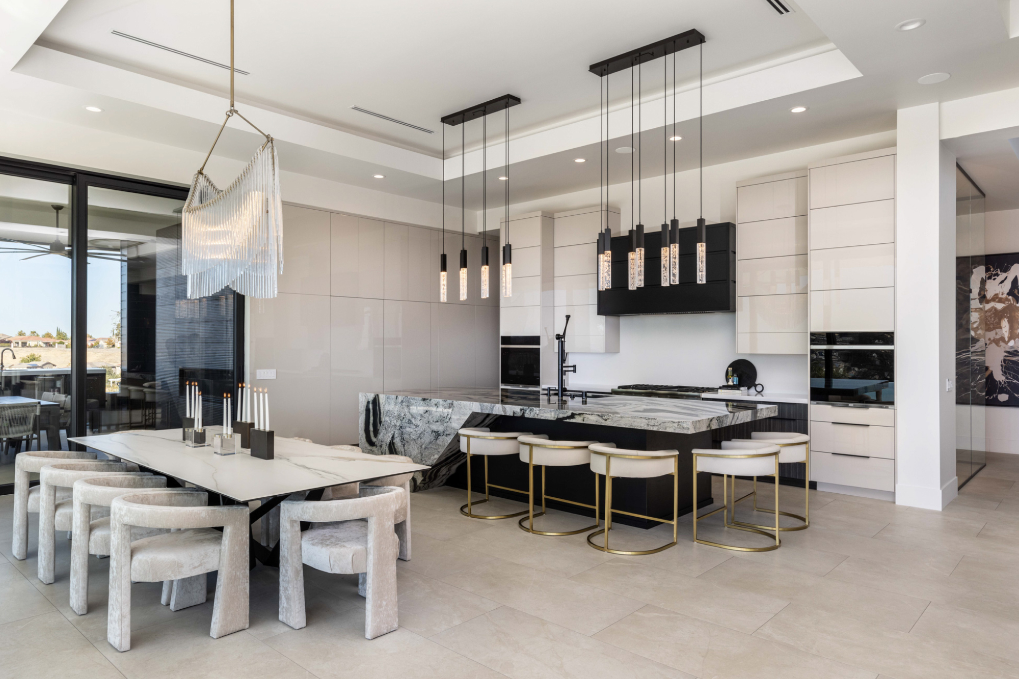 Contemporary kitchen and dining area featuring elegant design elements in Lincoln, CA. Modern lighting and marble accents enhance the space.